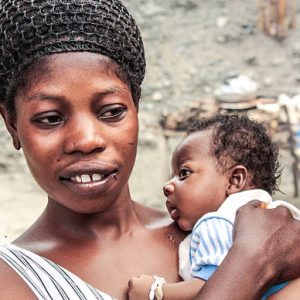 Anyinatiase village, Lake Bosumtwi, Ghana - July 31, 2010: Mother and her child portrait in small village Anyinatiase by the lake Bosumtwi in Ghana. Whole area has UNESCO sustainable management plan.